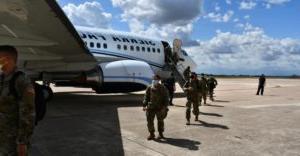 Soldiers exiting plane